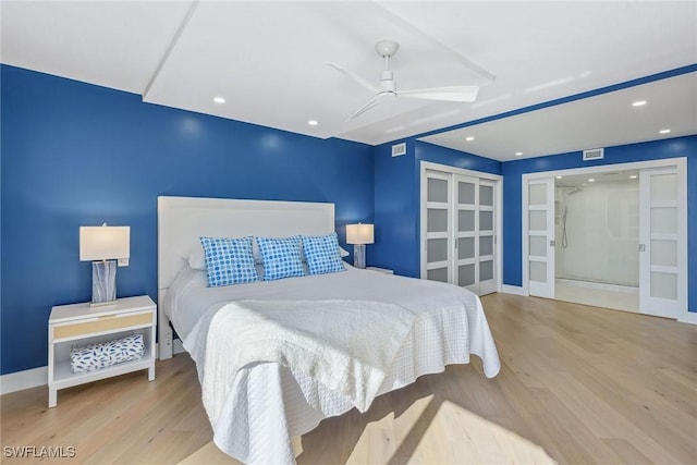 bedroom with french doors, ceiling fan, and light wood-type flooring