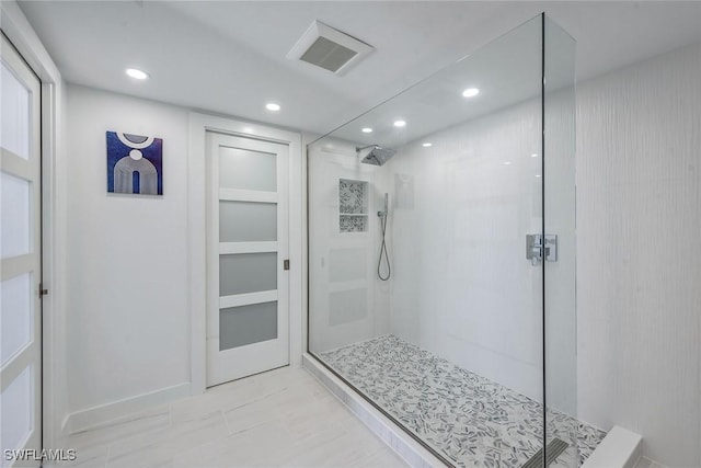 bathroom with a tile shower