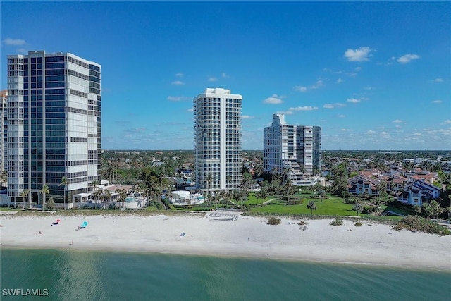 drone / aerial view featuring a beach view and a water view