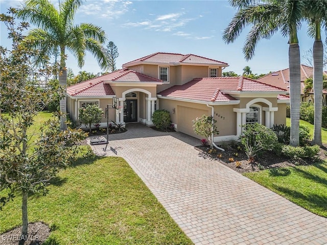 mediterranean / spanish home featuring a front yard