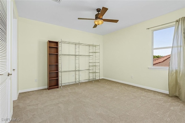 unfurnished bedroom with light carpet and ceiling fan