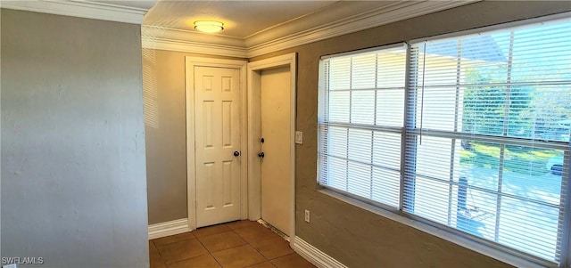 doorway with tile patterned flooring and crown molding