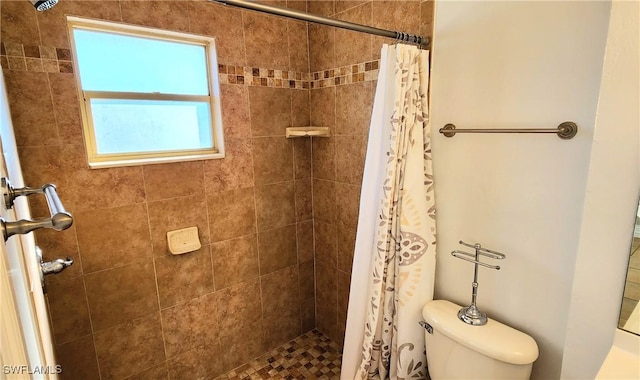 bathroom with toilet and walk in shower