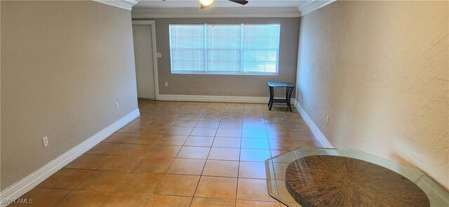 tiled spare room with ceiling fan and crown molding