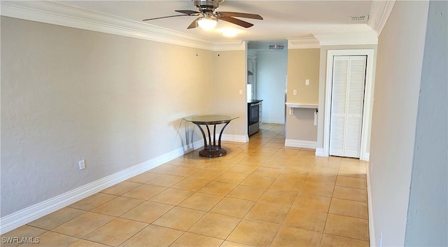 empty room featuring light tile patterned flooring, ceiling fan, and ornamental molding