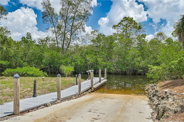 exterior space featuring a dock and a water view