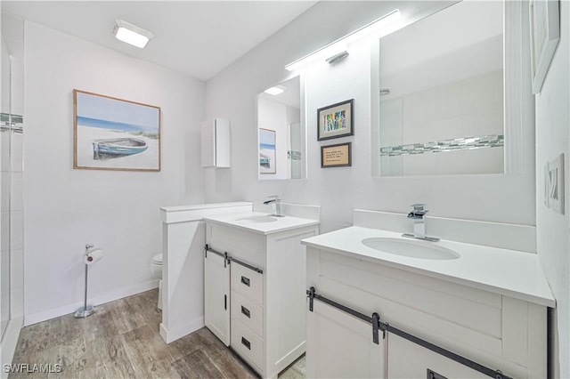 bathroom featuring hardwood / wood-style floors, vanity, and toilet