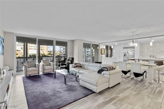 living room featuring an inviting chandelier and light hardwood / wood-style flooring