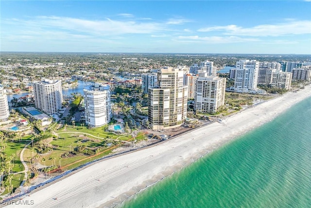 birds eye view of property featuring a water view and a beach view