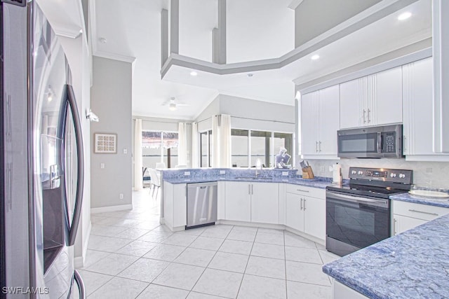 kitchen with sink, white cabinetry, appliances with stainless steel finishes, and decorative backsplash