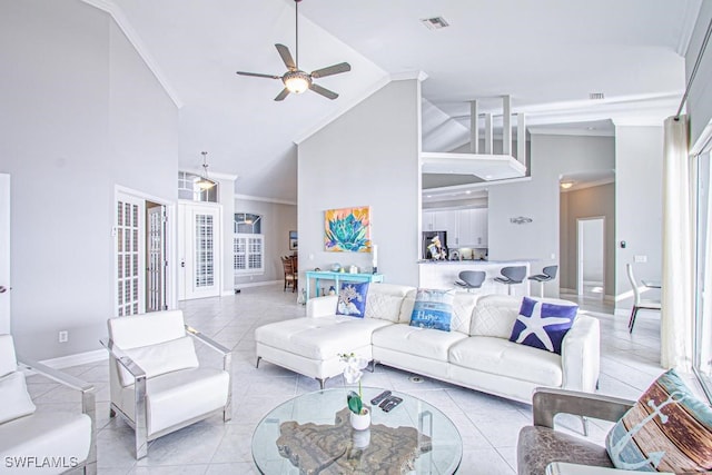 living room with crown molding, light tile patterned floors, french doors, high vaulted ceiling, and ceiling fan