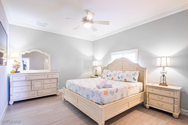 bedroom featuring crown molding, hardwood / wood-style floors, and ceiling fan