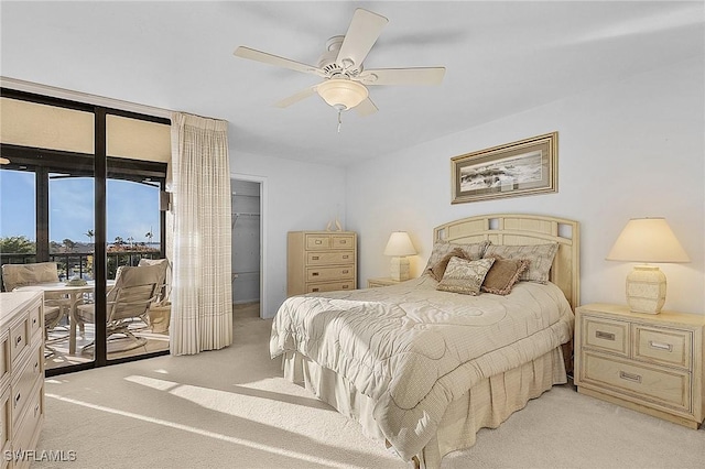 carpeted bedroom with access to exterior, a closet, and ceiling fan