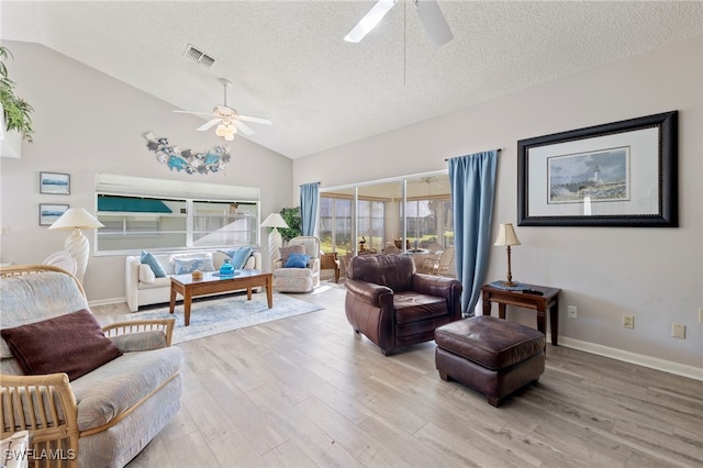 sitting room with a textured ceiling, ceiling fan, light hardwood / wood-style flooring, and vaulted ceiling