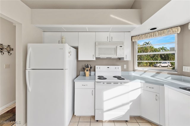 kitchen with white cabinetry, light tile patterned floors, and white appliances