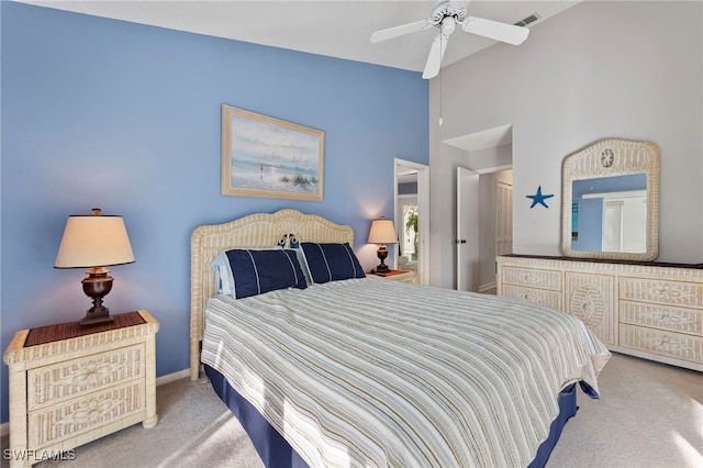 bedroom with ceiling fan, carpet floors, and a high ceiling