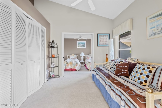 carpeted bedroom featuring a closet, ceiling fan, and lofted ceiling