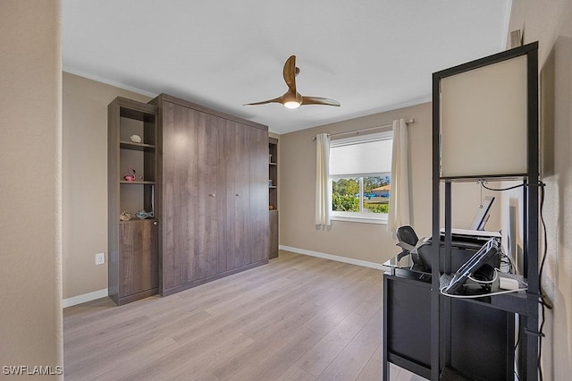 office space with ceiling fan, crown molding, and light hardwood / wood-style floors