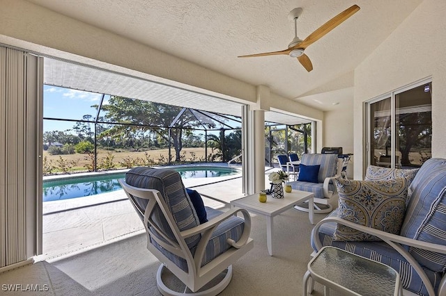 view of patio with a lanai, ceiling fan, and an outdoor living space