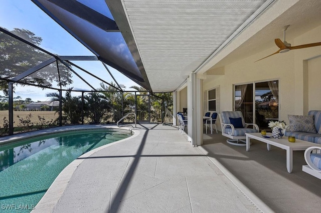 view of swimming pool with glass enclosure, ceiling fan, and a patio