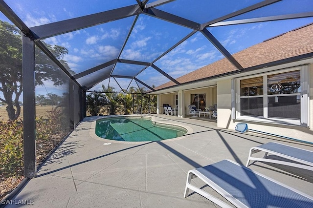 view of pool with a lanai and a patio