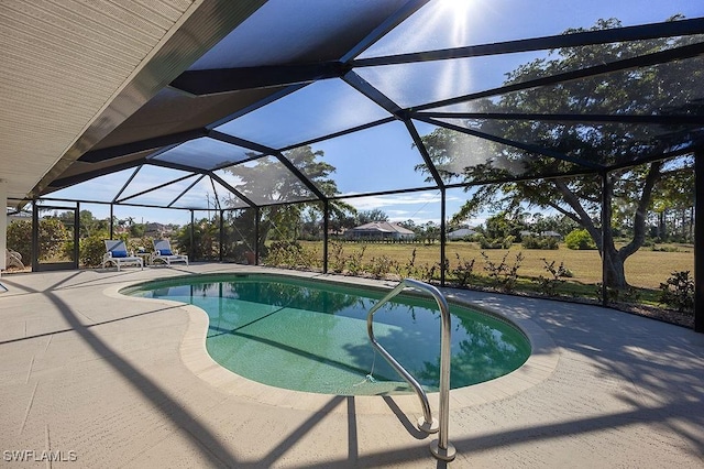 view of pool with a lanai and a patio area