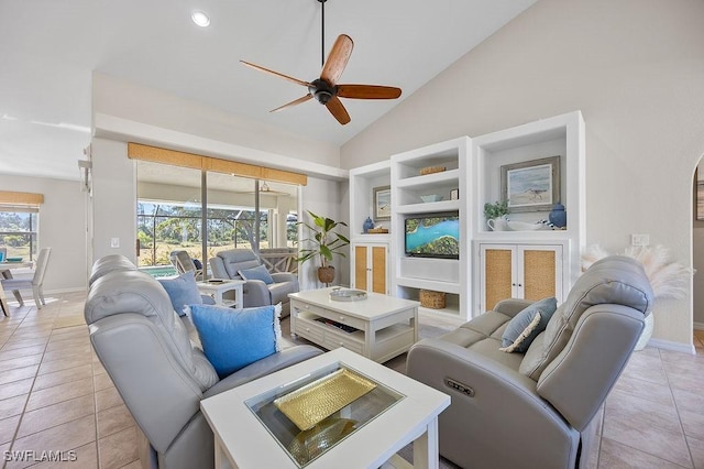 tiled living room featuring ceiling fan, french doors, and high vaulted ceiling