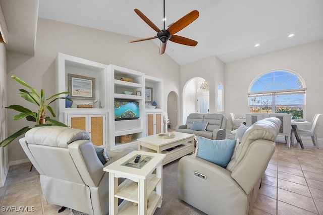 living room with ceiling fan, high vaulted ceiling, and light tile patterned floors