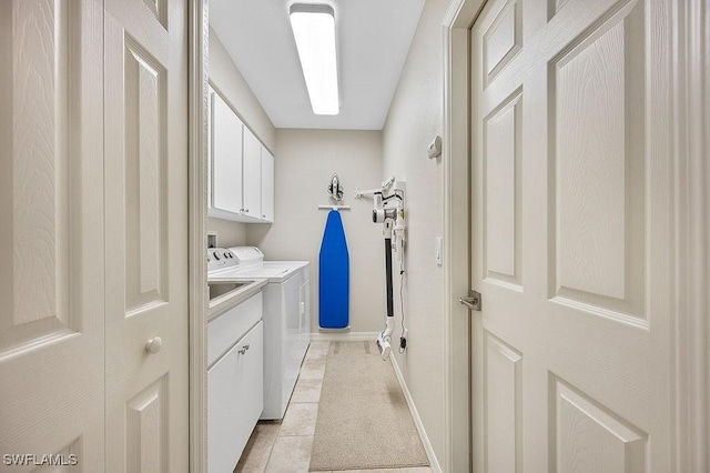 laundry room with cabinets, separate washer and dryer, and light tile patterned floors