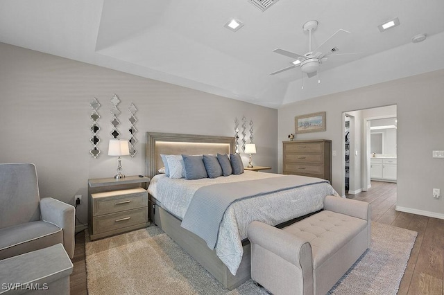 bedroom with a spacious closet, ceiling fan, and wood-type flooring