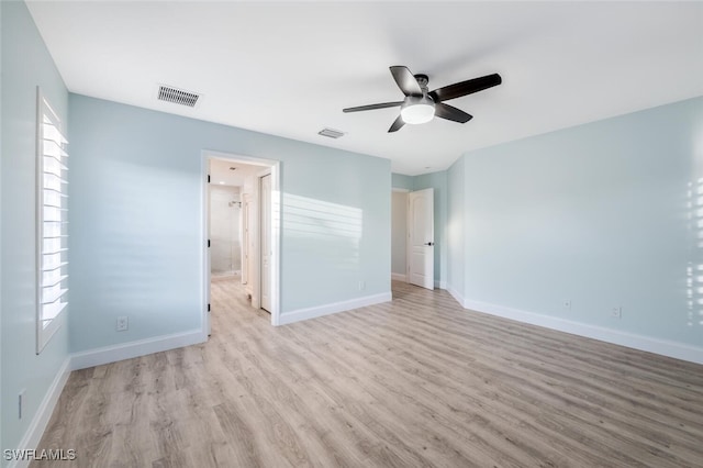 unfurnished bedroom featuring light wood-type flooring, ceiling fan, and connected bathroom