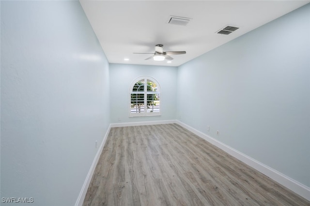 spare room featuring ceiling fan and light hardwood / wood-style flooring