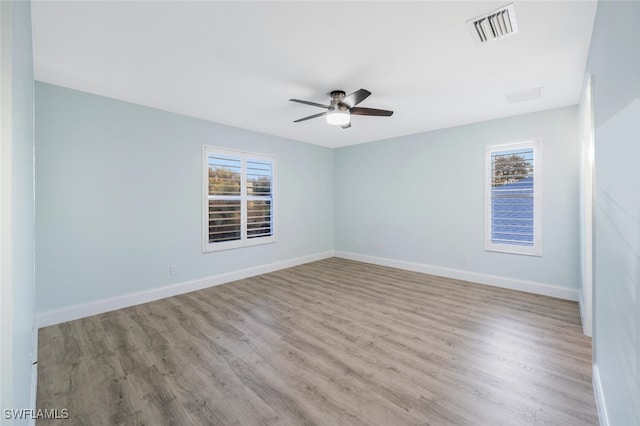 spare room featuring light hardwood / wood-style floors and ceiling fan