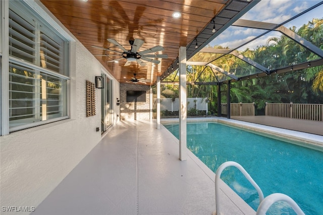 view of swimming pool with a lanai and a patio