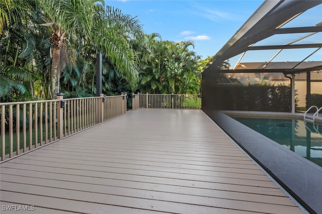 deck featuring a fenced in pool and a lanai