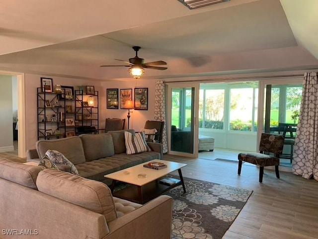 living room featuring ceiling fan and wood-type flooring