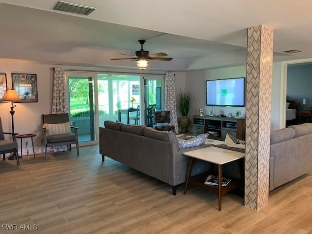 living room with light hardwood / wood-style floors and ceiling fan