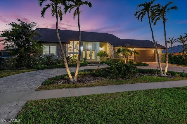 view of front of home featuring a lawn and a garage