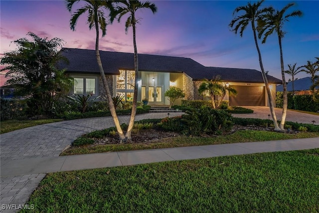 272 N Barfield Dr, Marco Island, FL 34145 - view of front of home featuring decorative driveway, french doors, a garage, and a front yard