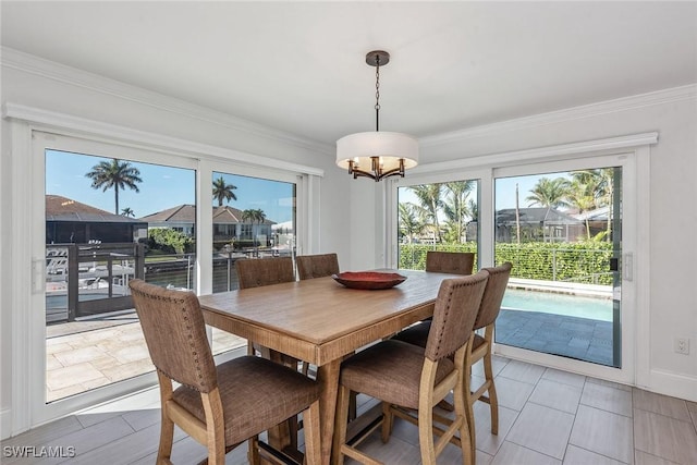 272 N Barfield Dr, Marco Island, FL 34145 - dining space featuring healthy amount of natural light, a chandelier, ornamental molding, and baseboards