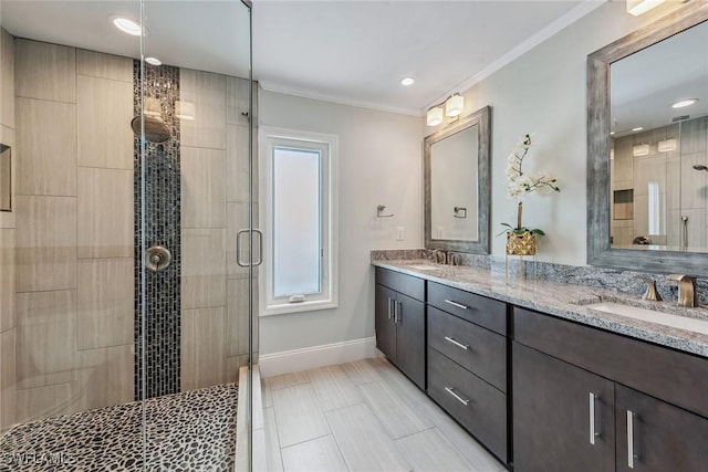 bathroom with vanity, crown molding, and walk in shower