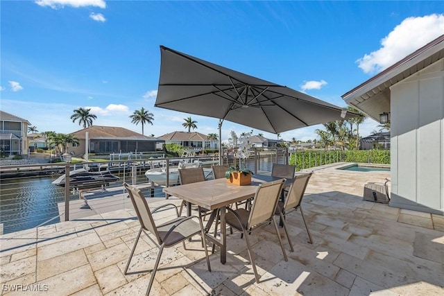 view of patio / terrace with a water view and a boat dock