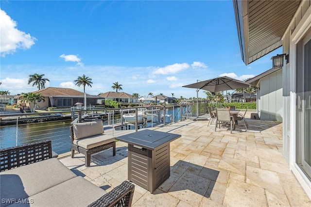 view of patio / terrace with a boat dock and a water view