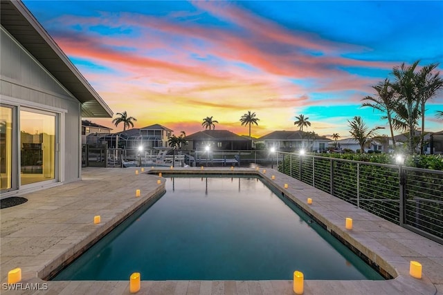 pool at dusk with a patio