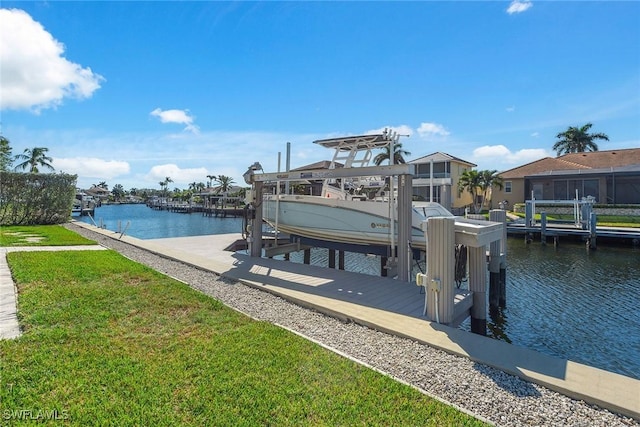 view of dock featuring a water view and a yard