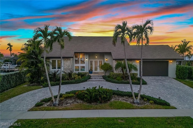 view of front of property featuring french doors and a garage