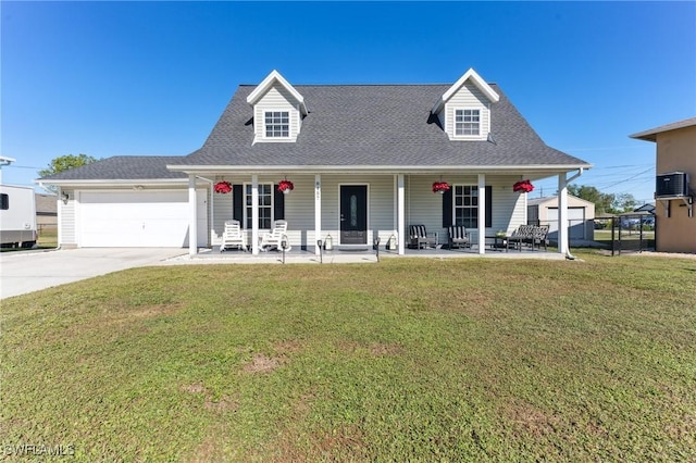 new england style home featuring a front lawn, a porch, and a garage