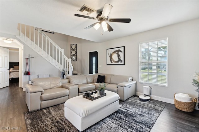 living room featuring ceiling fan and dark hardwood / wood-style flooring