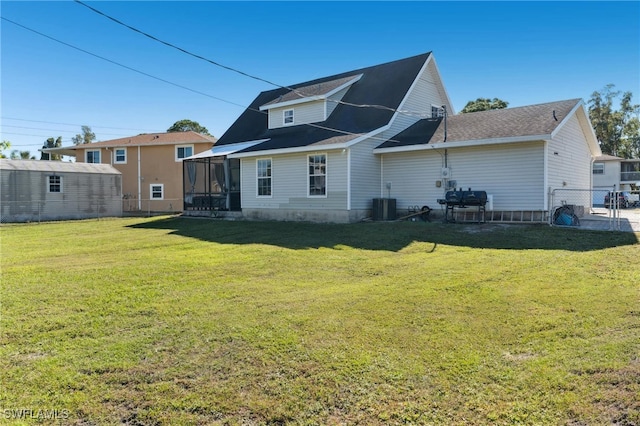 back of house featuring a sunroom and a yard