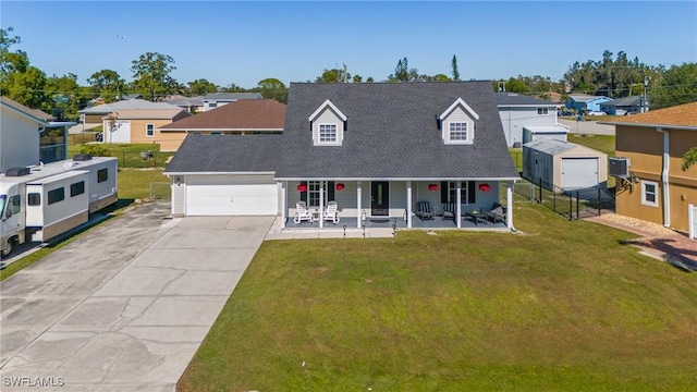 view of front of property with a porch, a garage, central air condition unit, and a front yard